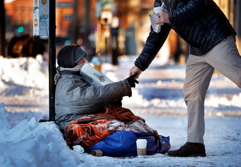 Illustration for article titled This Viral Photo of a Homeless Person Freezing on the Street Is Actually From 2013... in Canada